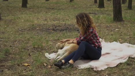 Girl-strokes-a-dog-in-the-forest