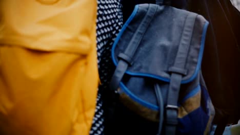 Camera-moves-around-happy-relaxed-young-romantic-tourist-couple-with-casual-backpacks-walking-together-on-a-winter-day.