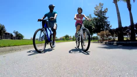 Active-ethnic-male-female-cycling-to-keep-fit