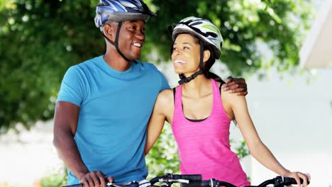 Young-active-African-American-couple-exercise-cycling-outdoors