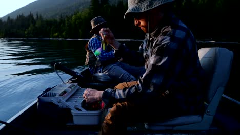 Two-fisherman-preparing-for-fishing-in-the-boat-4k