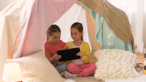 little-girls-with-tablet-pc-in-kids-tent-at-home