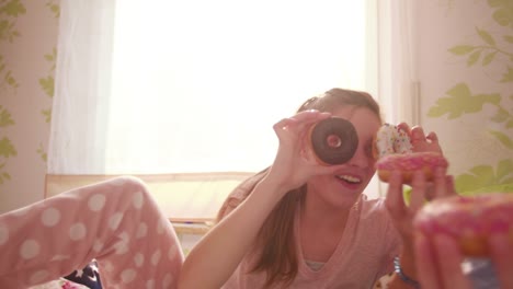 Girls-having-a-pyjama-party-with-sugary-donuts