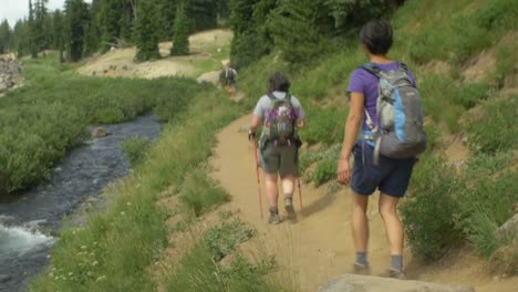 Camera-fallows-hikers-along-a-stream