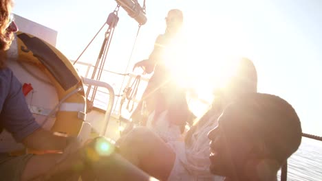 Girl-friends-drinking-beer-on-sunset-yacht-cruise-with-sunflare