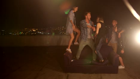 Teenager-friends-dancing-and-laughing-on-a-rooftop-party