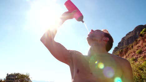 Young-adult-man-hydrating-after-after-a-good-run