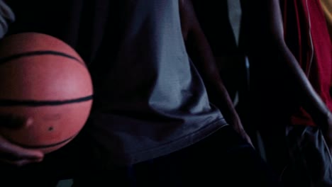 Group-of-Basketball-Players-Lined-up-Against-Court-Wall