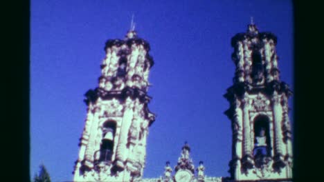 1978:-Religious-church-cathedral-building-tilt-down-blue-sky-sunny-day.