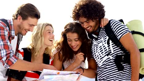 Hipster-group-of-friends-looking-at-map-together