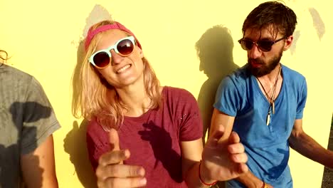 Close-up-of-cheerful-young-skateboarders-singing-and-dancing