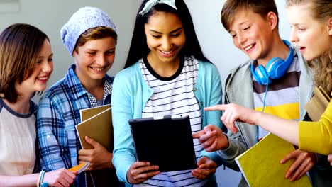 Group-of-students-using-digital-tablet-in-classroom