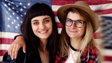 Blonde-and-brunette-hipster-girls-hold-a-flag