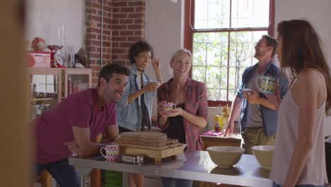 Five-friends-laughing-over-coffee-in-kitchen,-shot-on-R3D