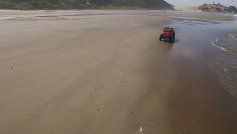 Aerial-shot-of-off-road-vehicle-driving-on-beach