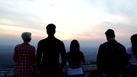 People-On-Mountain-Top-Back-Rear-View-Enjoying-Landscape,-Friends-Group-Tourists-Looking-At-Sunrise