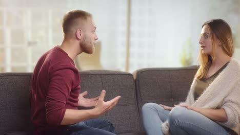 Young-couple-having-differences-on-a-couch