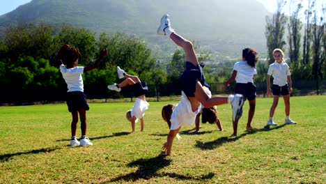 Children-performing-cart-wheel-during-race