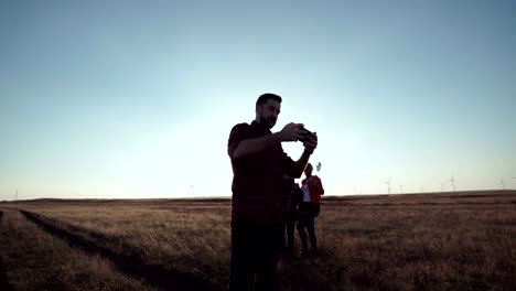 Man-taking-a-photograph-of-his-friends