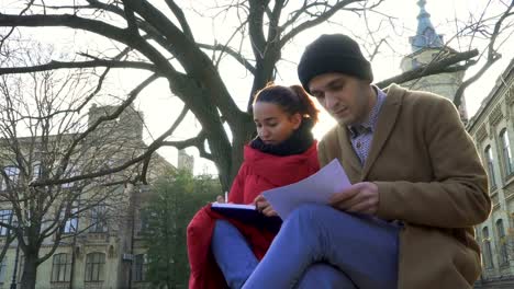 Two-students-discuss-exams-near-university