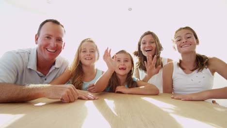 Caucasian-parents-daughters-using-Skype-uplink-on-yacht