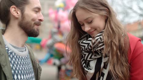 Romantic-couple-meeting-in-a-city.-Man-giving-woman-bunch-of-flowers.