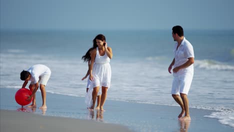 Latein-amerikanischen-Familie-spielen-zusammen-auf-Urlaub-am-Strand