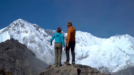 A-man-helps-a-girl-to-climb-a-rock