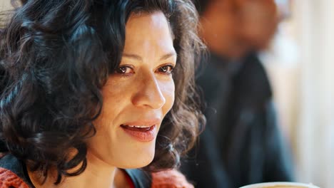 Middle-Aged-Woman-Meeting-Friends-Around-Table-In-Coffee-Shop