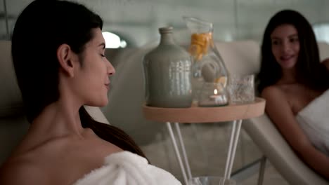 Young-women-with-towels-relaxing-at-spa-center