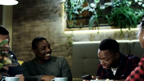 Black-cheerful-friends-enjoying-meeting-in-cafe