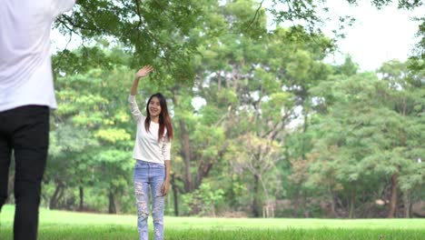 Teenage-waving-goodbye-at-outdoors-in-green-park.