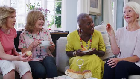 Senior-Female-Friends-Enjoying-Afternoon-Tea-At-Home-Together