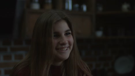 Portrait-of-smiling-girl-drinking-coffee-in-kitchen