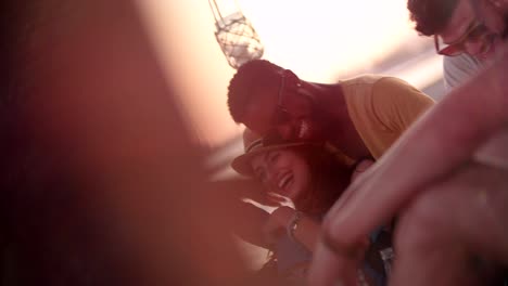 Multi-ethnic-hipster-couple-having-fun-with-friends-at-beach-party