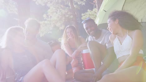 Friends-relaxing-on-a-picnic-blanket-looking-at-camera