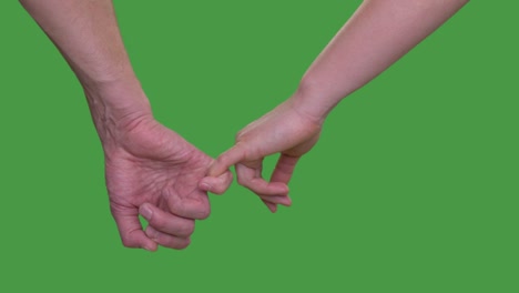 Male-hand-holding-female-hand-on-little-finger-on-green-background-close-up-Alpha-channel,-keyed-green-screen