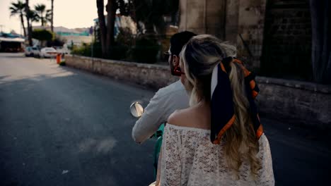 Young-tourists-couple-riding-scooter-on-summer-holidays-in-Italy