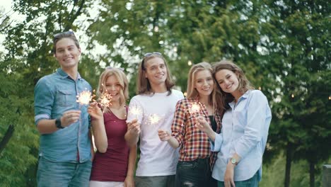 Happy-Friends-With-Sparklers-Having-Fun-Outdoors