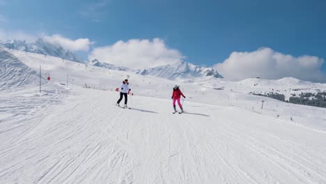 Two-Woman-Skiers-Skiing-Down-The-Ideal-Slope-Of-The-Mountain-In-Winter