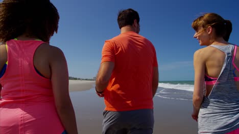 Multi-ethnic-friends-keeping-fit-on-beach-holiday