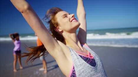 Portrait-of-Caucasian-American-woman-stretching-on-beach