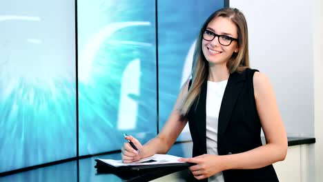 European-female-stylish-news-presenter-in-broadcasting-studio-medium-shot