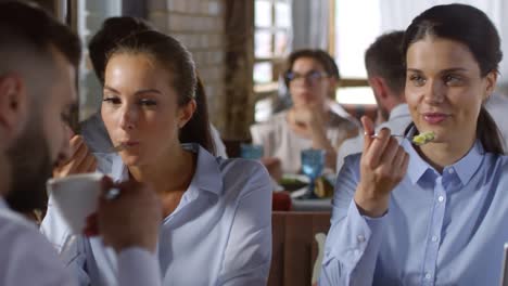 Businesspeople-Eating-in-Cafe-and-Discussing-Work