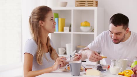 happy-couple-having-breakfast-at-home