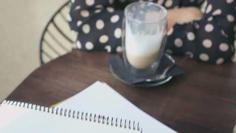 Artist-sketching-female-model-using-crayon-at-cafe