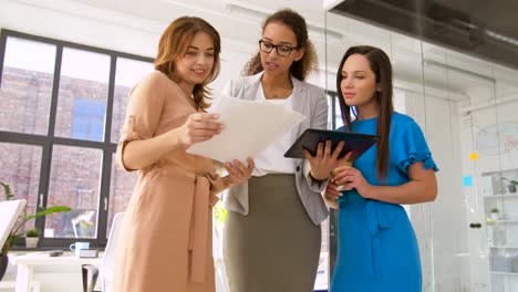 businesswomen-with-tablet-pc-and-charts-at-office