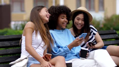 Chicas-riendo-viendo-divertido-video-en-línea-en-el-teléfono