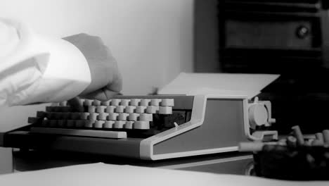 Smoking-journalist-typing-on-a-portable-typewriter