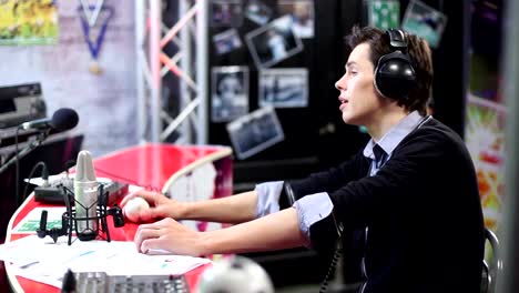 Young-adult-commenting-sport-event.-Radio-dj-in-his-room